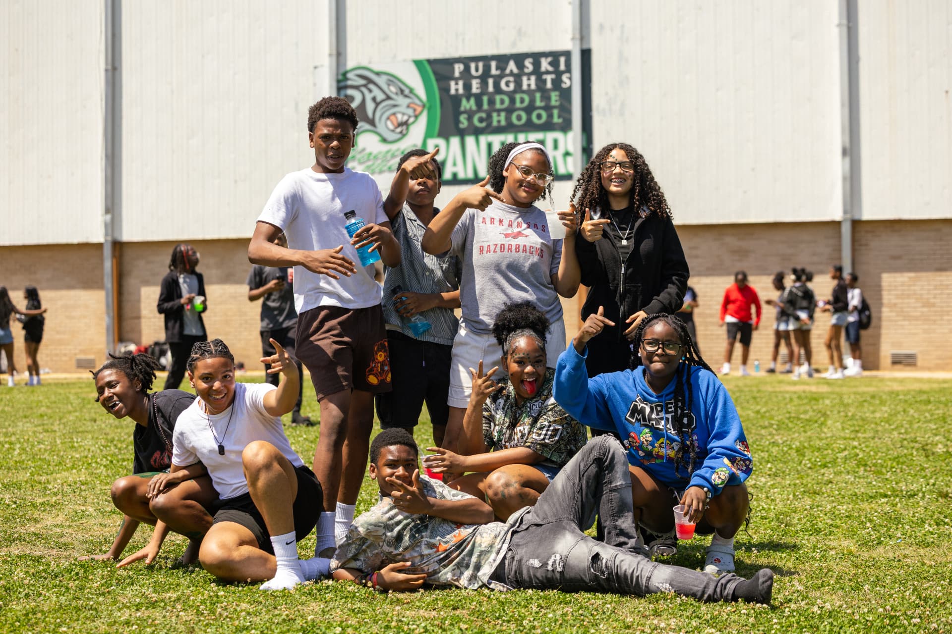 PHMS students posing together in front of the Pulaski Heights Panther sign