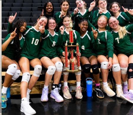 PHMS volleyball team celebrating with a trophy
