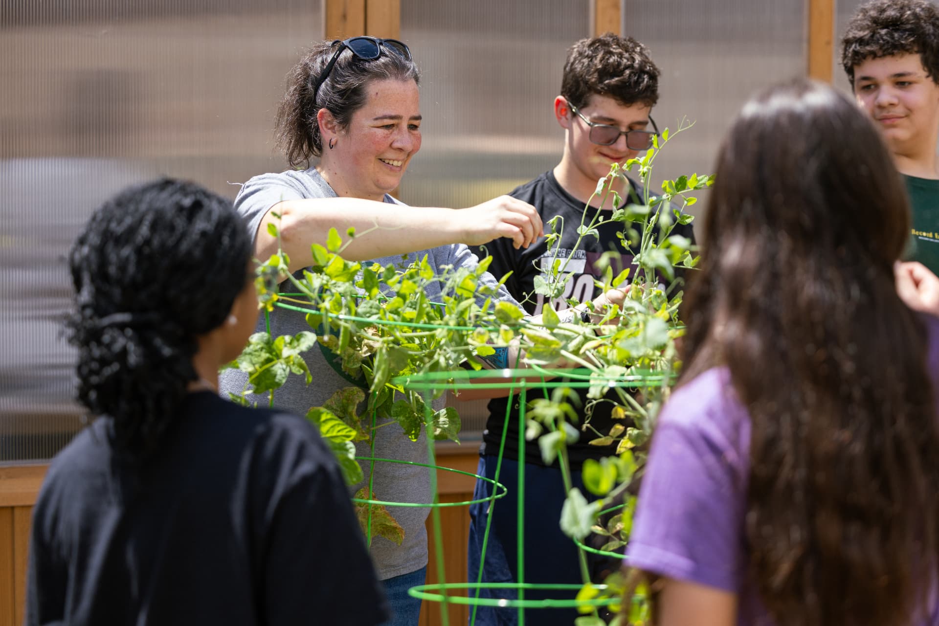 PHMS students and a teacher working in the garden