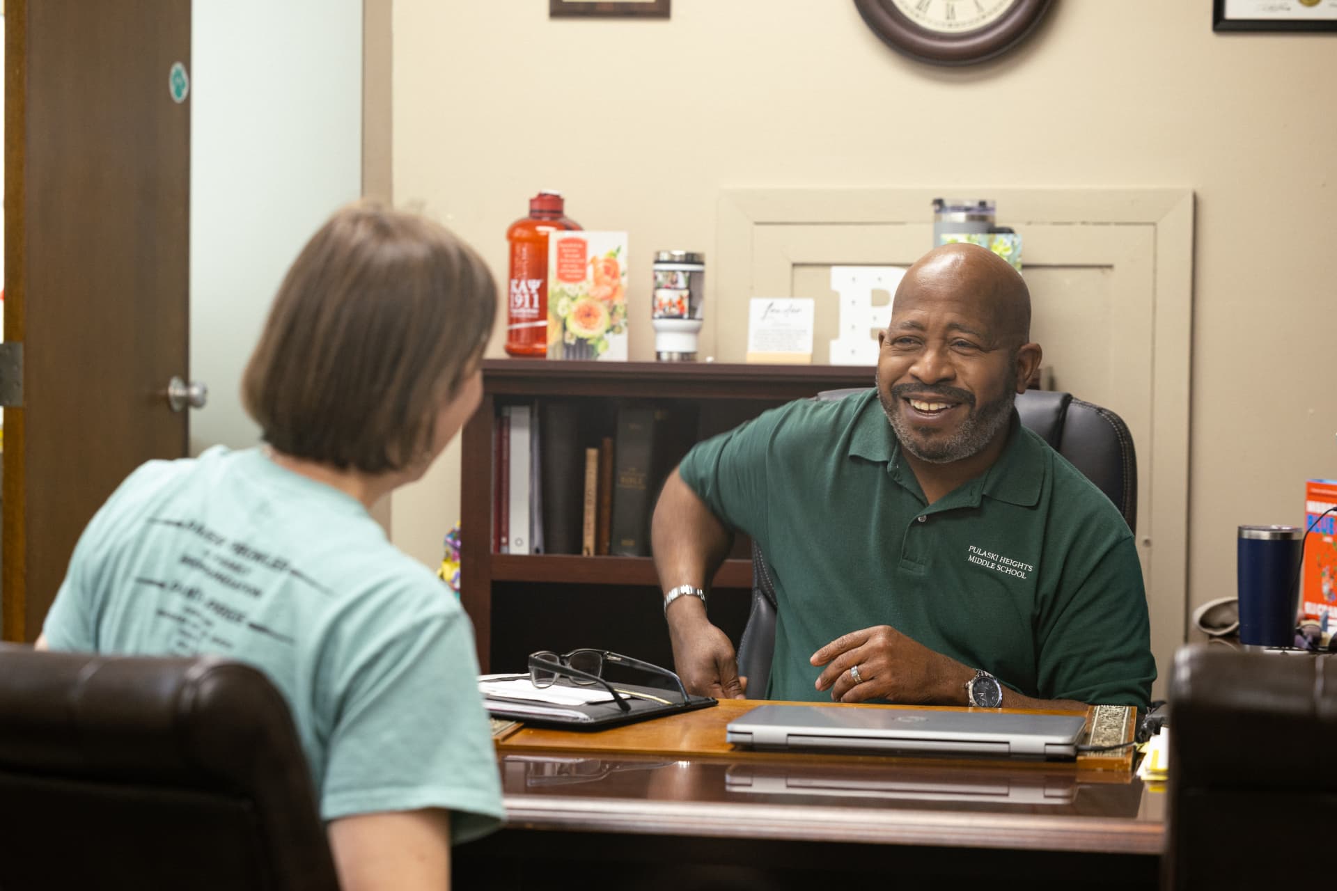 A PHMS staff member meeting with a parent in the school office